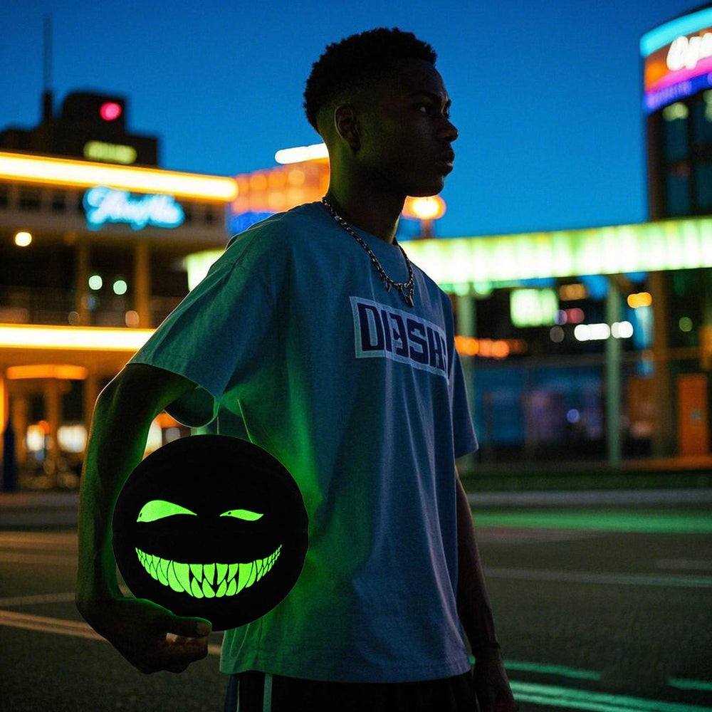 The model holds the glowing Kuangmi Devil Smiley Luminous Basketball at night