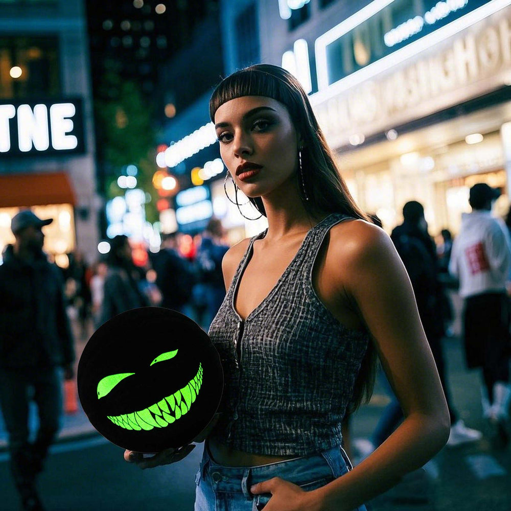 The female model holds the glowing Kuangmi Devil Smiley Luminous Basketball at night