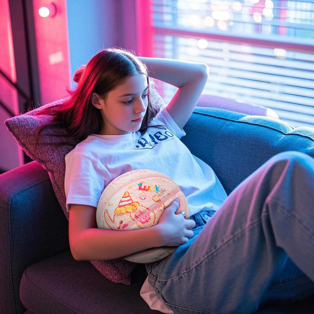 A girl is hugging Kuangmi Adorable Elephant on the sofa - themed Basketball